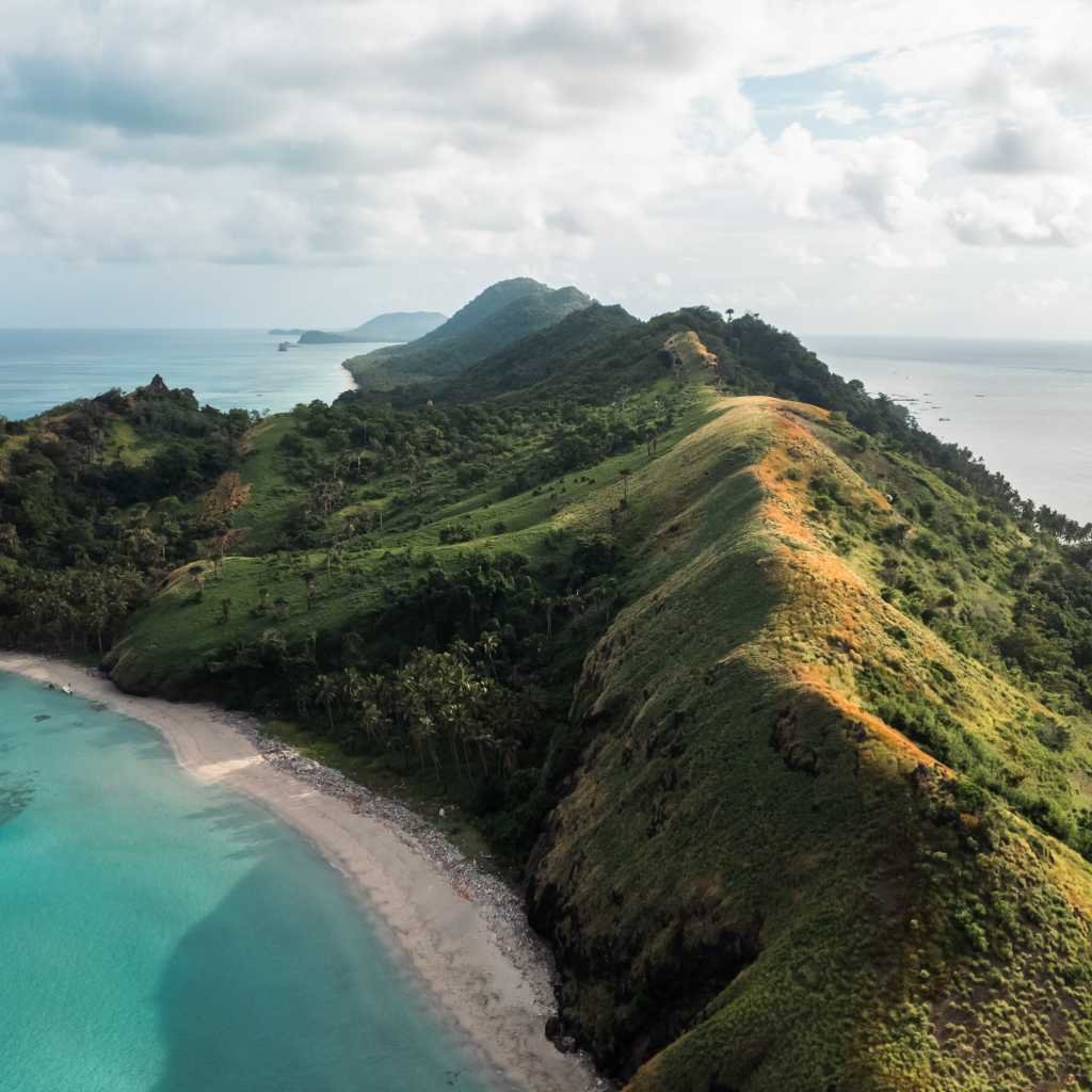 Green ridge and white beach on the Selayar coast